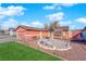 Well-manicured front yard with green grass, gravel, and a decorative tree; providing great curb appeal at 3920 Geist Ave, Las Vegas, NV 89115