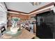 Traditional kitchen with wooden cabinetry, black refrigerator, and a cozy dining area at 3920 Geist Ave, Las Vegas, NV 89115