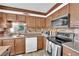 Bright kitchen with wooden cabinetry, stainless steel appliances and a window over the sink at 3920 Geist Ave, Las Vegas, NV 89115