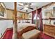 Ornate primary bedroom with a four-poster bed, patterned wallpaper, and elegant decor at 3920 Geist Ave, Las Vegas, NV 89115