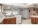 Traditional kitchen featuring a stainless steel sink, white dishwasher, and access to the outdoor patio through sliding glass doors at 4134 Grace St, Las Vegas, NV 89121