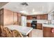 Functional kitchen with white appliances, tile countertops, and eat-in dining space at 4134 Grace St, Las Vegas, NV 89121