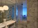 Sleek bathroom with a bathtub, a rainfall shower head, and marble tile at 4381 W Flamingo Rd # 903, Las Vegas, NV 89103