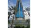 Modern high-rise exterior with glass facade and palm trees against a sunny sky, offering city views at 4381 W Flamingo Rd # 903, Las Vegas, NV 89103
