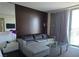 Comfortable living room featuring a neutral color palette and glass doors opening to a balcony at 4381 W Flamingo Rd # 903, Las Vegas, NV 89103