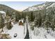 Aerial view of a charming house in a snow covered mountain landscape surrounded by trees at 4587 Yellow Pine Ave, Mount Charleston, NV 89124