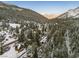 Stunning aerial view of a snow-covered mountain community nestled among tall pine trees and winding roads at 4587 Yellow Pine Ave, Mount Charleston, NV 89124