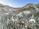 Breathtaking aerial view of a snow-covered mountain community with winding roads and homes at 4587 Yellow Pine Ave, Mount Charleston, NV 89124