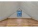Empty attic space with white walls, wood flooring and a window at 4587 Yellow Pine Ave, Mount Charleston, NV 89124