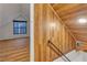 View of attic space showing the wood wall and flooring leading to another room with natural light at 4587 Yellow Pine Ave, Mount Charleston, NV 89124