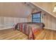 Cozy attic bedroom with wood-paneled walls and sloped ceiling, features a warm and inviting atmosphere at 4587 Yellow Pine Ave, Mount Charleston, NV 89124