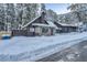 Cozy cabin has stone accents, surrounded by snow-covered landscape, blending rustic charm with winter beauty at 4587 Yellow Pine Ave, Mount Charleston, NV 89124