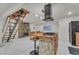 Spacious living area features a stone fireplace, unique staircase, and modern lighting at 4587 Yellow Pine Ave, Mount Charleston, NV 89124