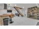 Bright living room boasts a stone fireplace, unique staircase, and modern lighting at 4587 Yellow Pine Ave, Mount Charleston, NV 89124
