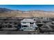 Aerial view of a backyard with a pool, lounge chairs, and a covered patio with an outdoor kitchen at 4612 Amazing View St, Las Vegas, NV 89129