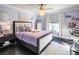 Light purple bedroom featuring a plush bed, wood flooring, and a white faux fur rug at 4612 Amazing View St, Las Vegas, NV 89129