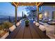 Outdoor dining area by the pool, featuring a long table and string lights, perfect for evening gatherings at 4612 Amazing View St, Las Vegas, NV 89129