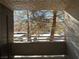 Balcony view overlooking parking area and mature trees, providing natural light and a sense of openness at 5024 S Rainbow Blvd # 203, Las Vegas, NV 89118