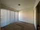 Well-lit bedroom featuring neutral tones, carpet flooring, a ceiling fan, and a sliding door closet at 5024 S Rainbow Blvd # 203, Las Vegas, NV 89118