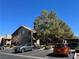 Complex exterior with well-maintained landscaping, ample parking, and mature shade trees on a bright, sunny day at 5024 S Rainbow Blvd # 203, Las Vegas, NV 89118