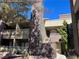 Building exterior featuring multiple units, private balconies, and manicured landscaping with a mix of gravel and shrubbery at 5024 S Rainbow Blvd # 203, Las Vegas, NV 89118