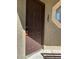 Close-up of the unit door with visible unit number, featuring a decorative octagonal window and neutral stucco siding at 5024 S Rainbow Blvd # 203, Las Vegas, NV 89118