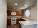 Cozy kitchen with wooden cabinets, white appliances, and laminate countertops, offering a functional cooking space at 5024 S Rainbow Blvd # 203, Las Vegas, NV 89118