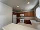 Functional kitchen featuring wood cabinetry, white appliances, and laminate countertops, bathed in natural light at 5024 S Rainbow Blvd # 203, Las Vegas, NV 89118