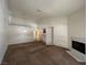Bright living room featuring vaulted ceilings, a corner fireplace, and a view into the adjacent kitchen area at 5024 S Rainbow Blvd # 203, Las Vegas, NV 89118