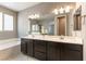 This bathroom features dual sinks, a large mirror, and a separate tub and shower at 5646 Sophie Belle Ave, Las Vegas, NV 89131