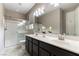 This bathroom features dual sinks, a large mirror, a toilet and a shower at 5646 Sophie Belle Ave, Las Vegas, NV 89131