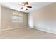 This is a spacious bedroom with neutral walls and carpet, and a window at 5646 Sophie Belle Ave, Las Vegas, NV 89131
