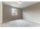 This bedroom has neutral walls and carpet and a window at 5646 Sophie Belle Ave, Las Vegas, NV 89131
