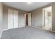 This bedroom has neutral walls, carpet, and an attached bathroom at 5646 Sophie Belle Ave, Las Vegas, NV 89131