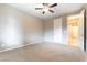 Comfortable bedroom featuring neutral walls, plush carpet, and a ceiling fan at 5646 Sophie Belle Ave, Las Vegas, NV 89131