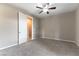 This is a spacious bedroom with neutral walls and carpet, and a ceiling fan at 5646 Sophie Belle Ave, Las Vegas, NV 89131