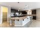Modern kitchen featuring dark cabinetry, stainless steel appliances, and a large island at 5646 Sophie Belle Ave, Las Vegas, NV 89131