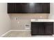 This laundry room has cabinets, a sink, and washer and dryer hookups at 5646 Sophie Belle Ave, Las Vegas, NV 89131