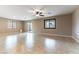 Spacious living room with tile flooring, fan, and sliding glass door leading to backyard at 5646 Sophie Belle Ave, Las Vegas, NV 89131