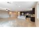 Open concept living room and kitchen area with tile floors and recessed lighting at 5646 Sophie Belle Ave, Las Vegas, NV 89131