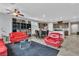 Open-concept living room featuring modern furniture, tile flooring, and access to the kitchen at 5716 Alitak Bay St, North Las Vegas, NV 89081