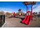 Bright and colorful playground with slides, climbing structures, and a safety surface at 5716 Alitak Bay St, North Las Vegas, NV 89081