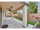 Covered patio area with ceiling fan, artificial grass, and block wall at 5928 Radiance Park St, North Las Vegas, NV 89081