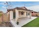 Covered back patio with artificial grass and a well-maintained yard at 5928 Radiance Park St, North Las Vegas, NV 89081