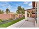 Back patio with a covered outdoor seating area and artificial grass at 5928 Radiance Park St, North Las Vegas, NV 89081