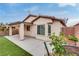 Backyard featuring a covered patio, artificial turf, and mature landscaping at 5928 Radiance Park St, North Las Vegas, NV 89081