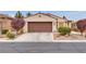 Inviting single-story home with a two-car garage and desert landscaping at 5928 Radiance Park St, North Las Vegas, NV 89081