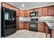 Updated kitchen featuring stainless steel appliances, granite countertops, and dark cabinets at 5928 Radiance Park St, North Las Vegas, NV 89081