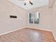 Neutral bedroom with a window and wood-look floors at 62 E Serene Ave # 114, Las Vegas, NV 89123