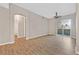 Bedroom with hardwood floors, ceiling fan, and sliding glass door to balcony at 62 E Serene Ave # 114, Las Vegas, NV 89123